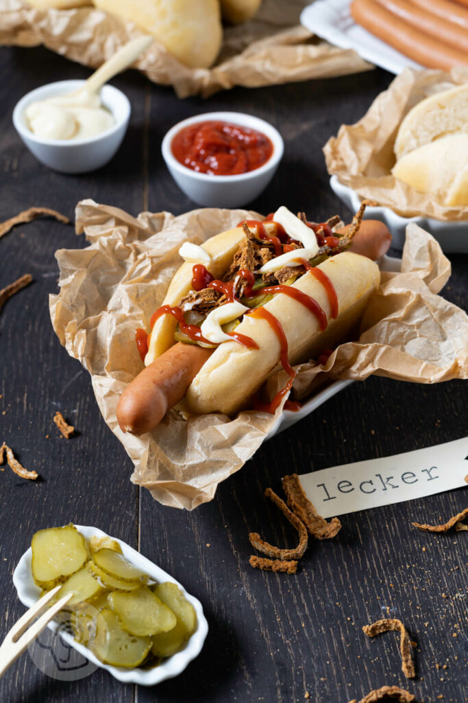 Hot Dog mit Gewürzgurken, Röstzwiebeln, Ketchup und Mayo