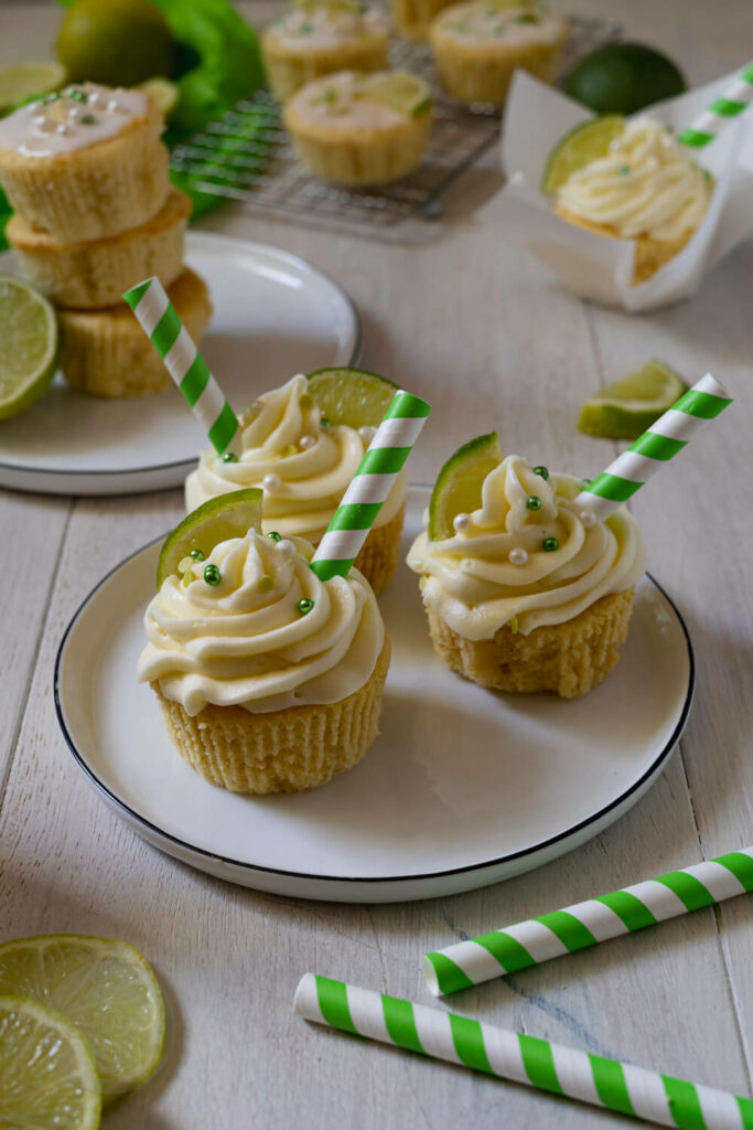 Gin Tonic Cupcakes 3 Gin Tonic Cupcakes mit Strohhalmen und Limetten.