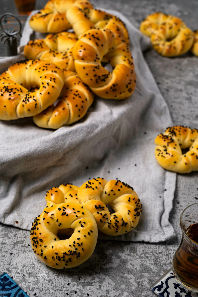 Acma - türkische Brötchen aus Hefeteig auf einem Rost, dazu Tee