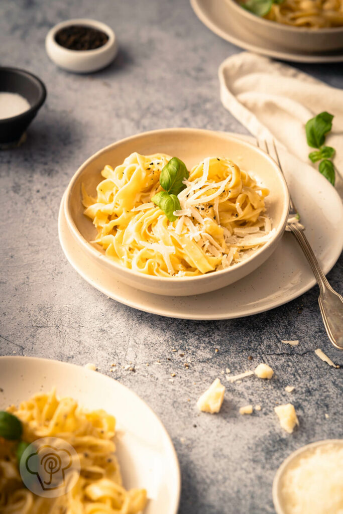 Schnelle Fettuccine Alfredo - Gericht aus 3 Zutaten 9 Fettuccine Alfredo mit Parmesan auf einem Teller